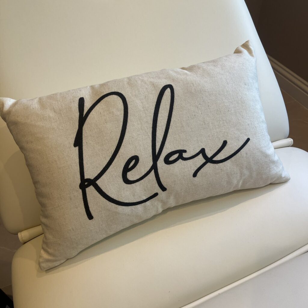 Cream cushion with the word Relax written on it